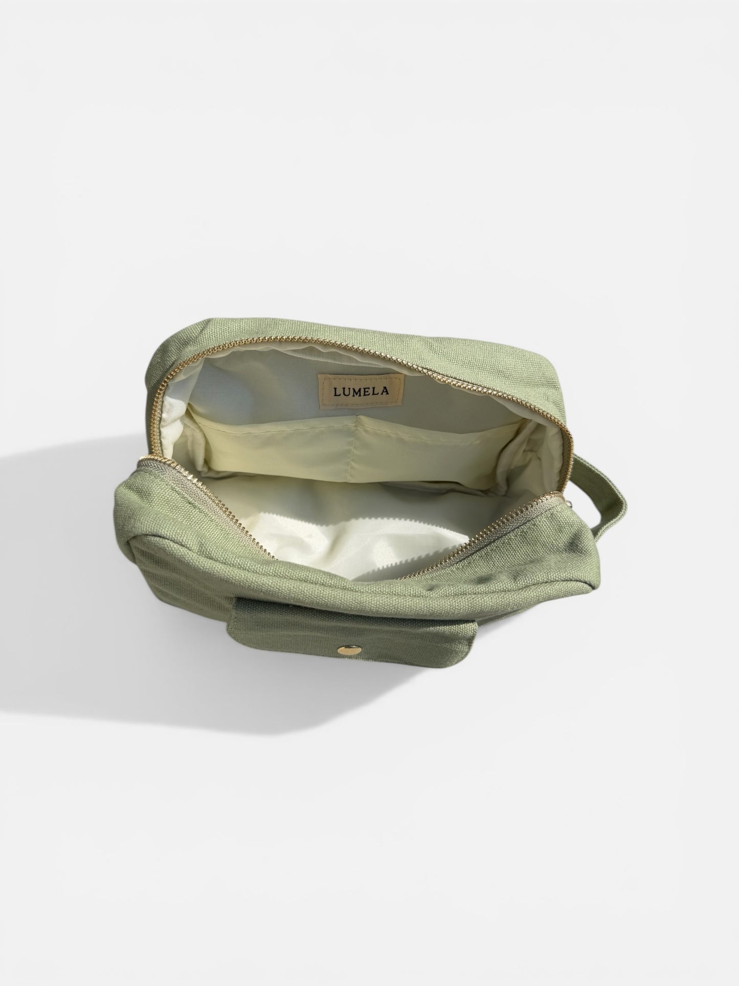 Olive green canvas makeup bag inside view lining and storage space