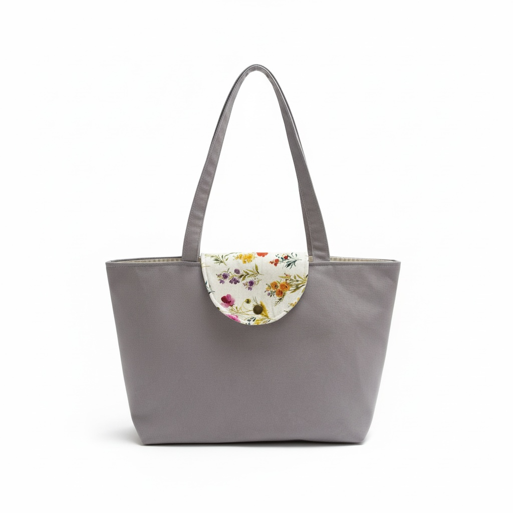 Gray tote bag with floral detail on a white background