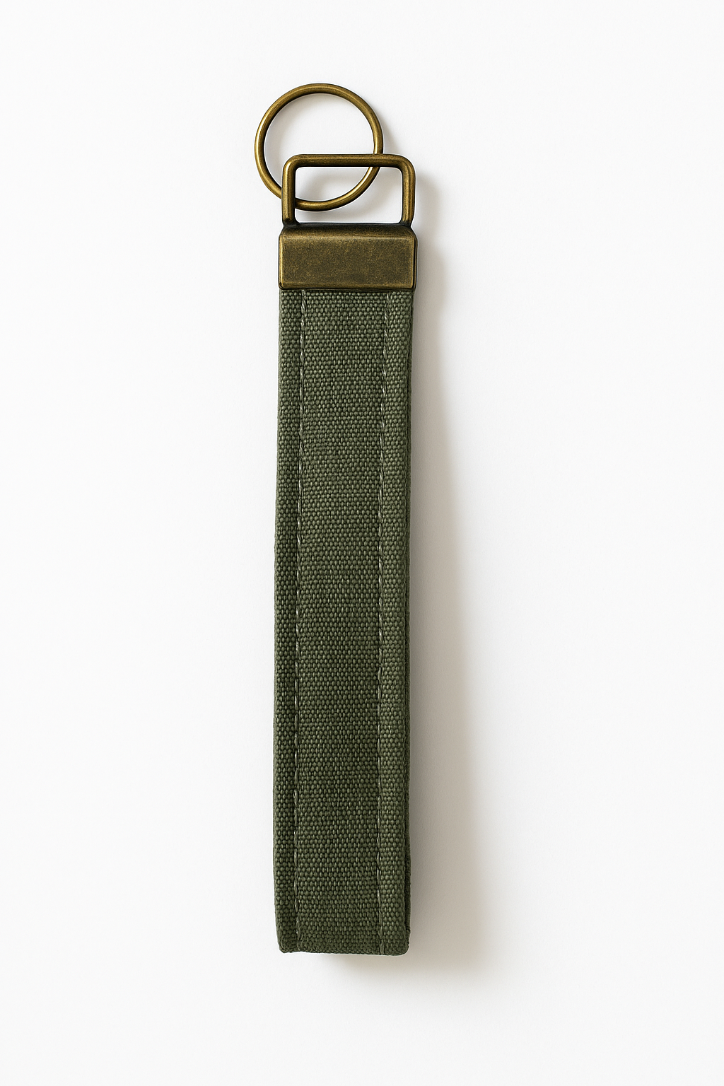 Olive green canvas wristlet keychain with brass hardware on white background