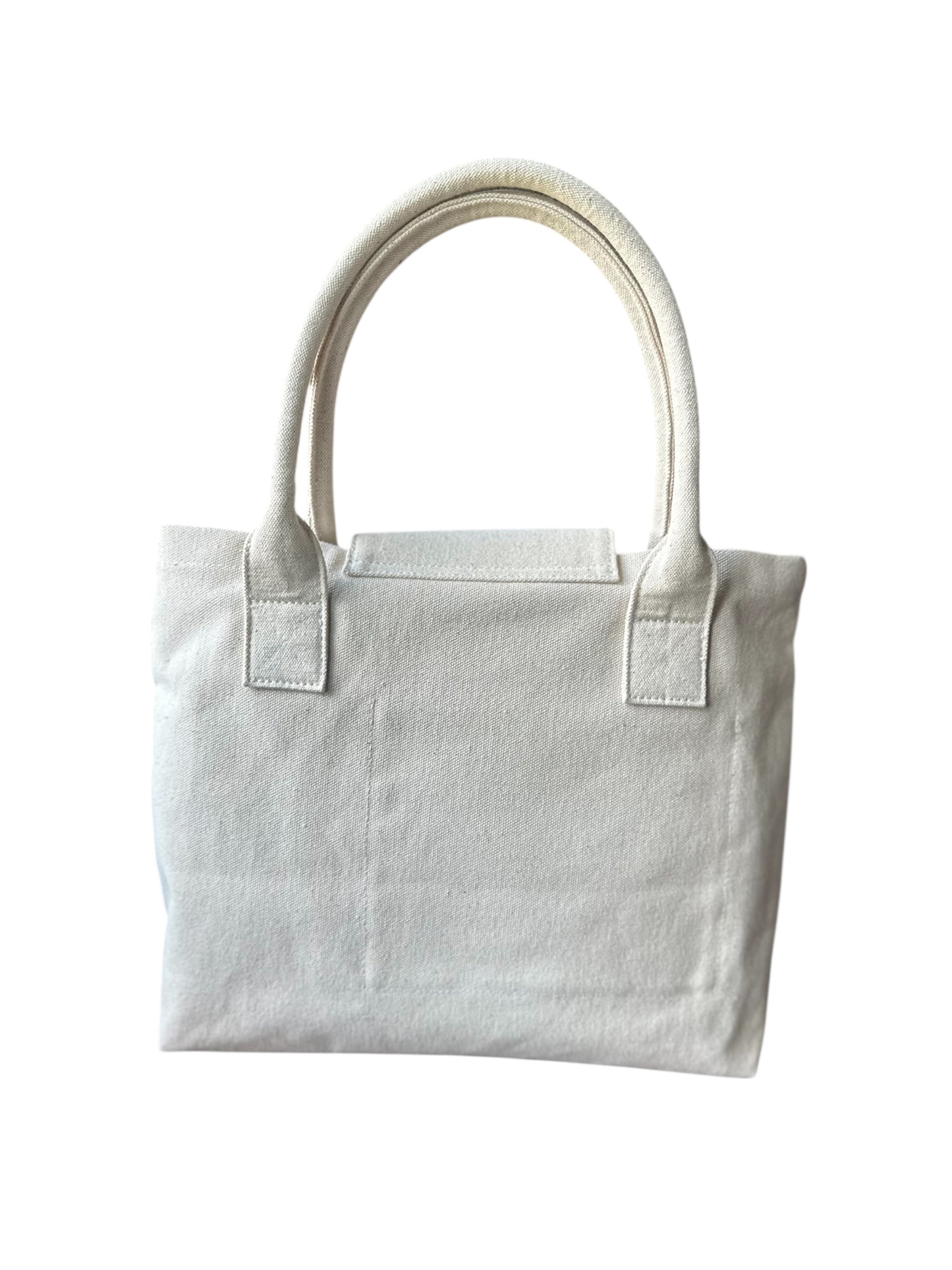 Minimalist white canvas tote bag with dual handles on white background