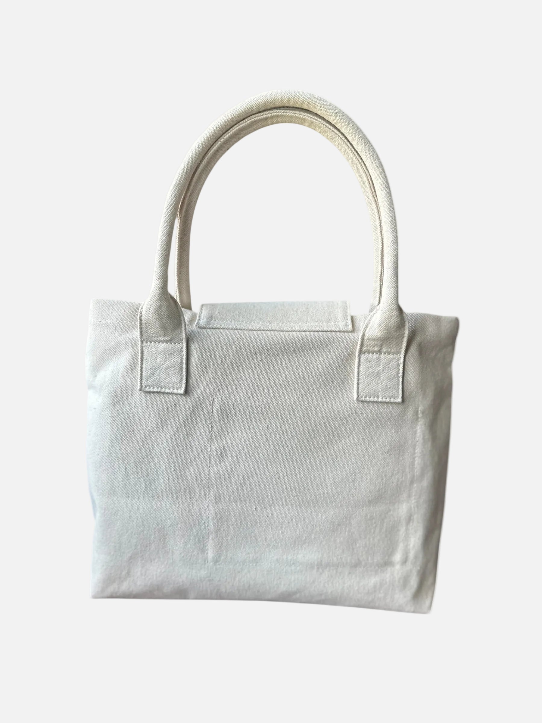 Minimalist white canvas tote bag with dual handles on white background