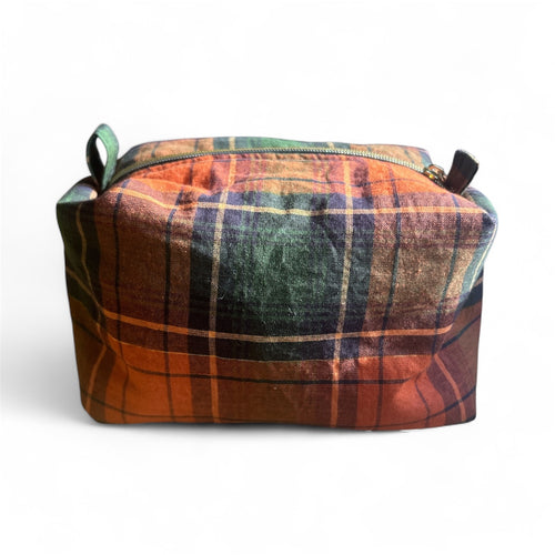 Plaid canvas pouch with zipper in orange and green minimalist design on white background