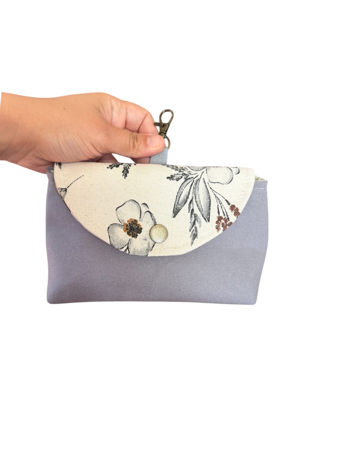 Gray Meadow canvas clip-on pouch held in hand showing size