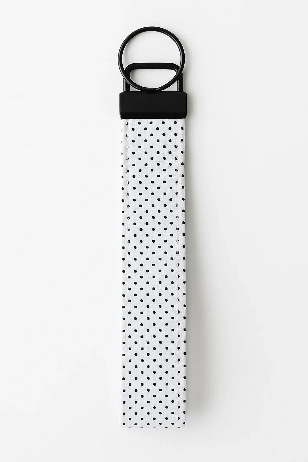 White fabric keychain wristlet with black polka dots and black metal hardware