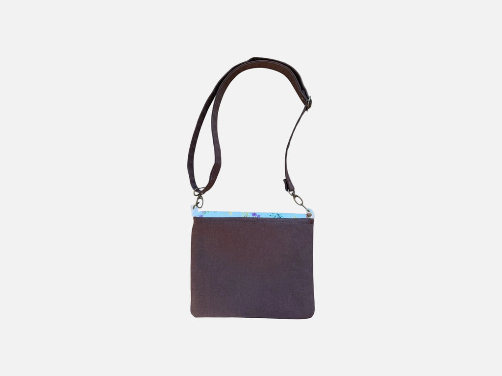Back view of Cocoa canvas tote bag with black straps and floral snap closure