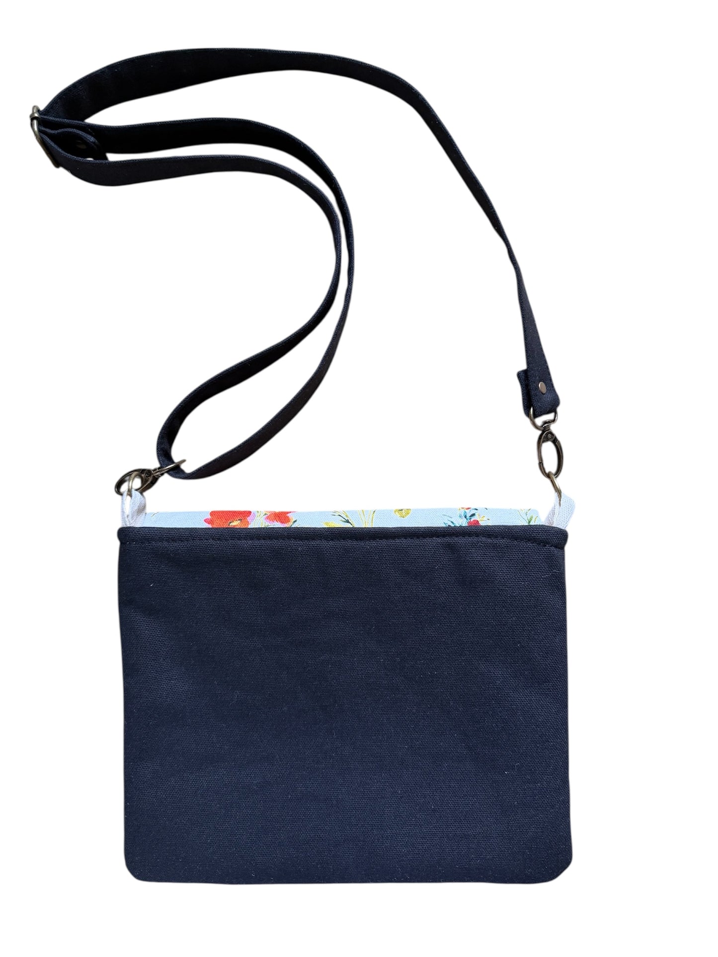 Back view of canvas tote bag with floral pocket and black straps