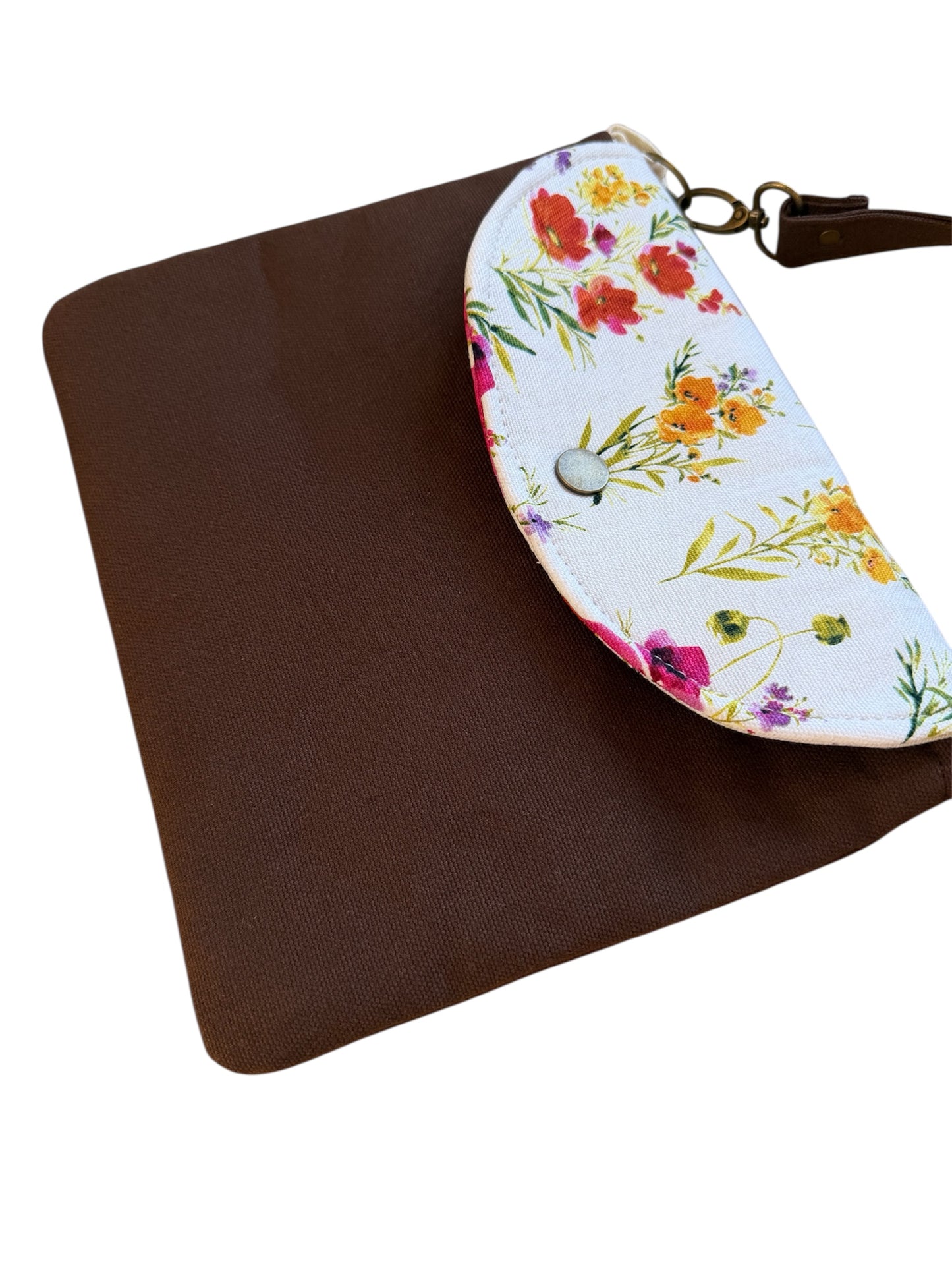 Cocoa canvas tote bag with floral snap closure on white background