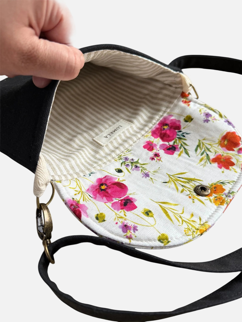 Inside view of canvas tote bag with floral lining and zipper closure
