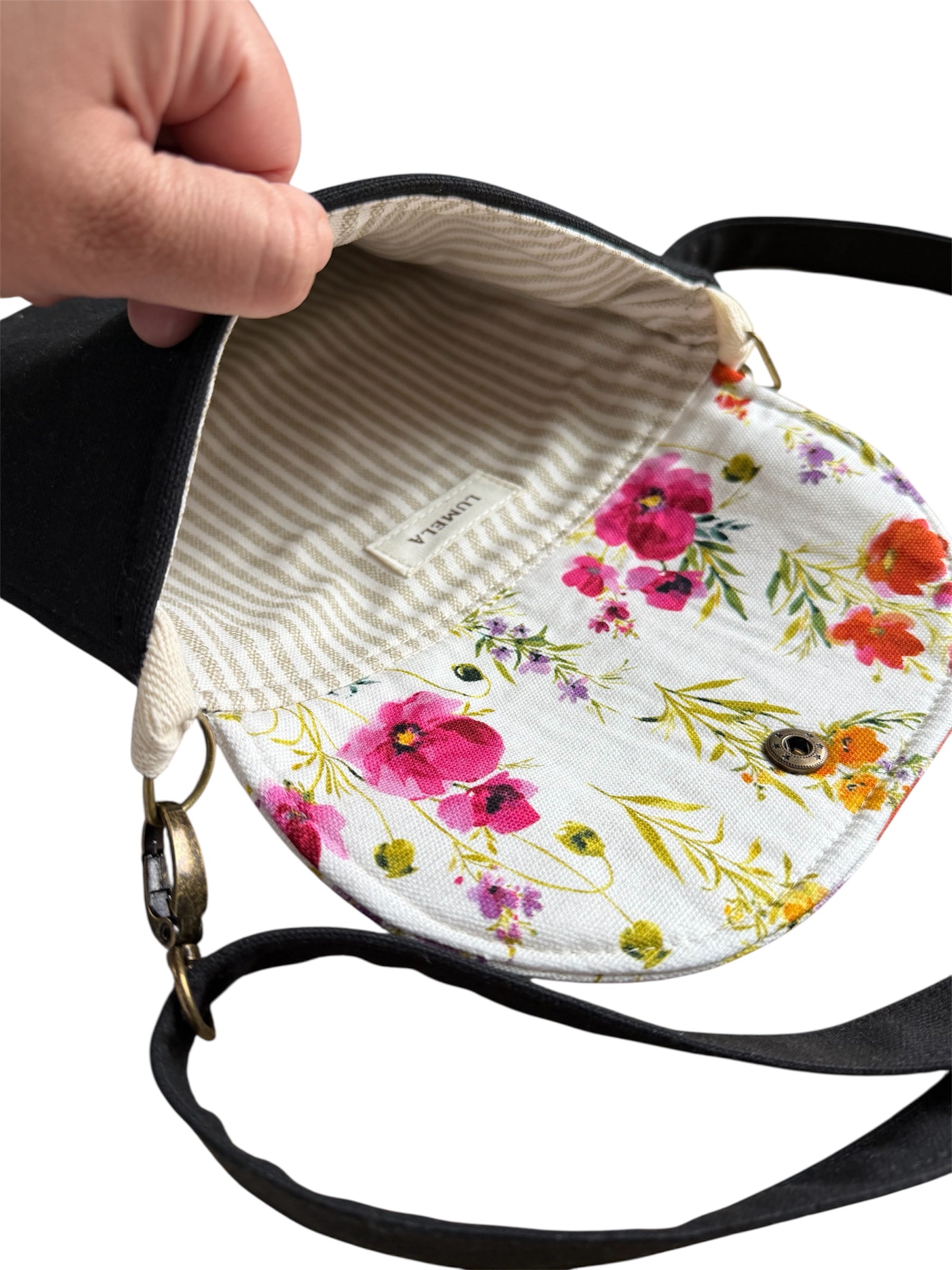Inside view of canvas tote bag with floral lining and zipper closure