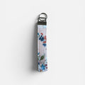 Floral keychain strap on a peach background
