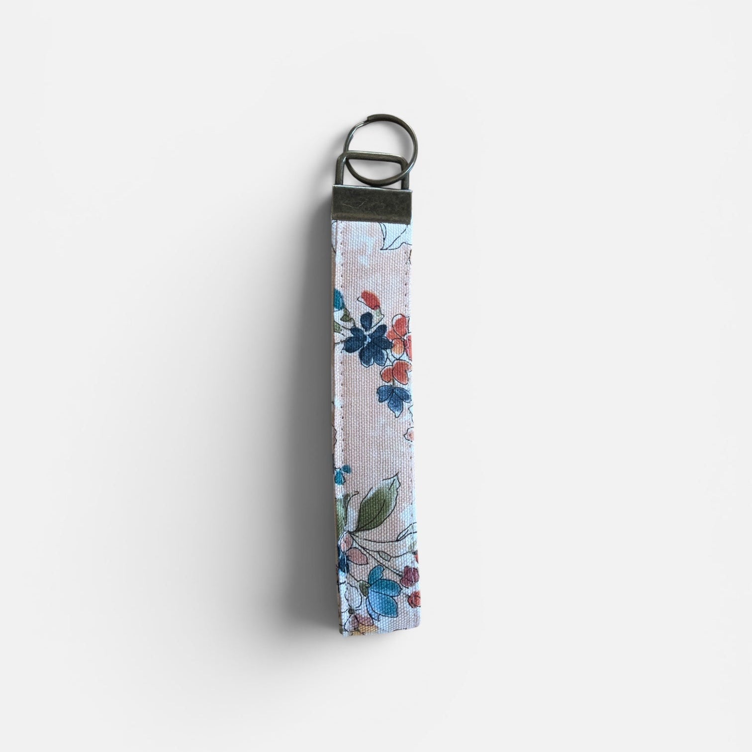 Floral keychain strap on a peach background